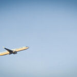 Airplane taking off into the morning sky