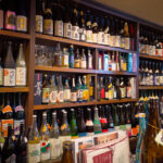 An impressive number of shochu bottles lined up behind the bar
