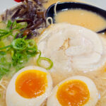 Close-up of tonkotsu ramen at Hakata KIKI, showing broth, thin noodles, and a boiled egg.