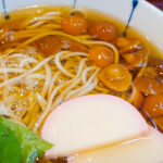Close-up view of the thickened soba broth enriched by nameko mushrooms.