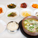Various side dishes, rice, and soup. A Korean-style table setting