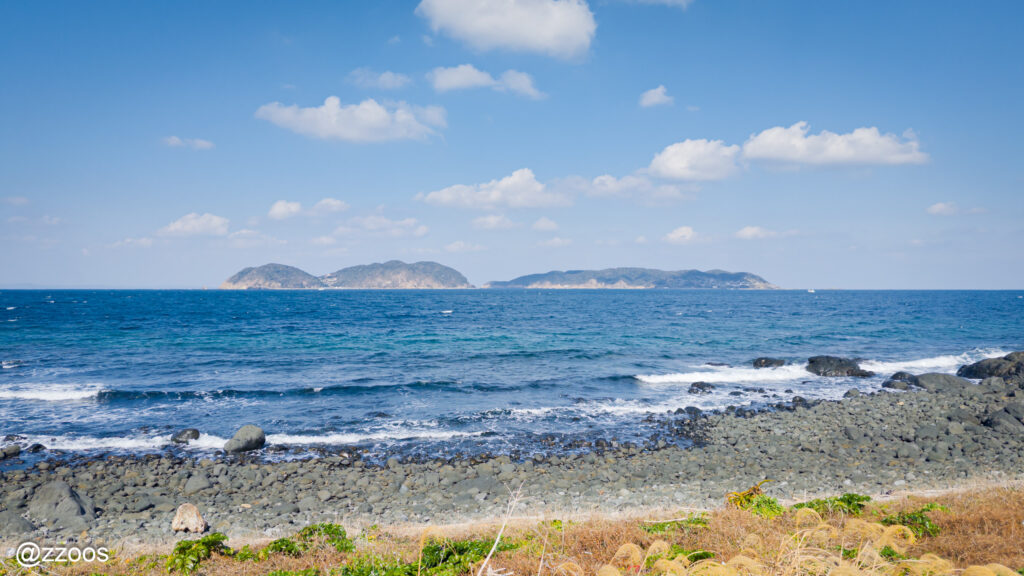 The deep blue sea and a distant island.