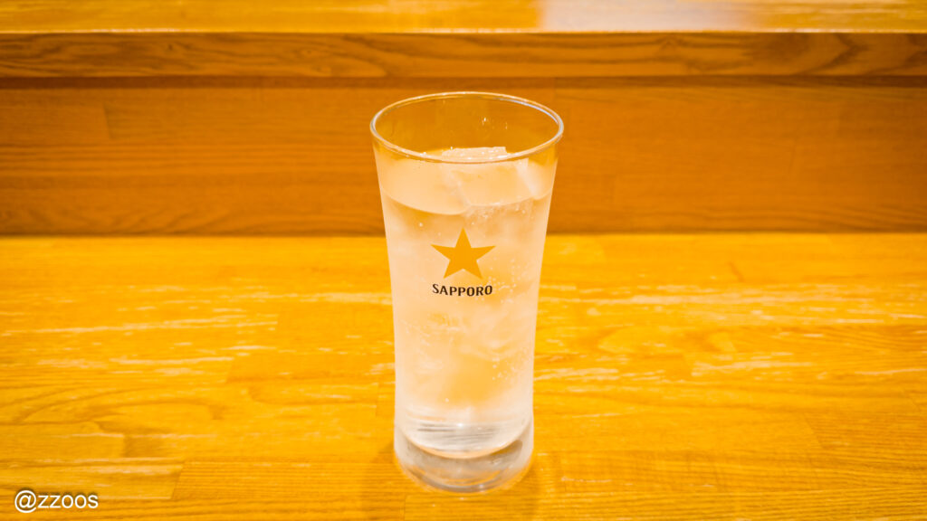 Shochu soda served in a Sapporo beer glass