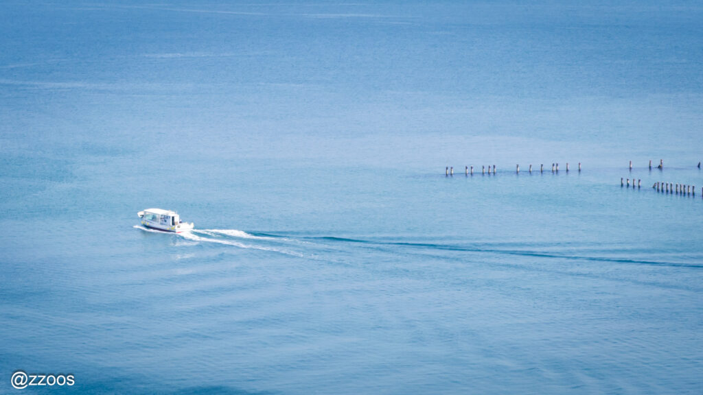 A small boat cutting through the sea