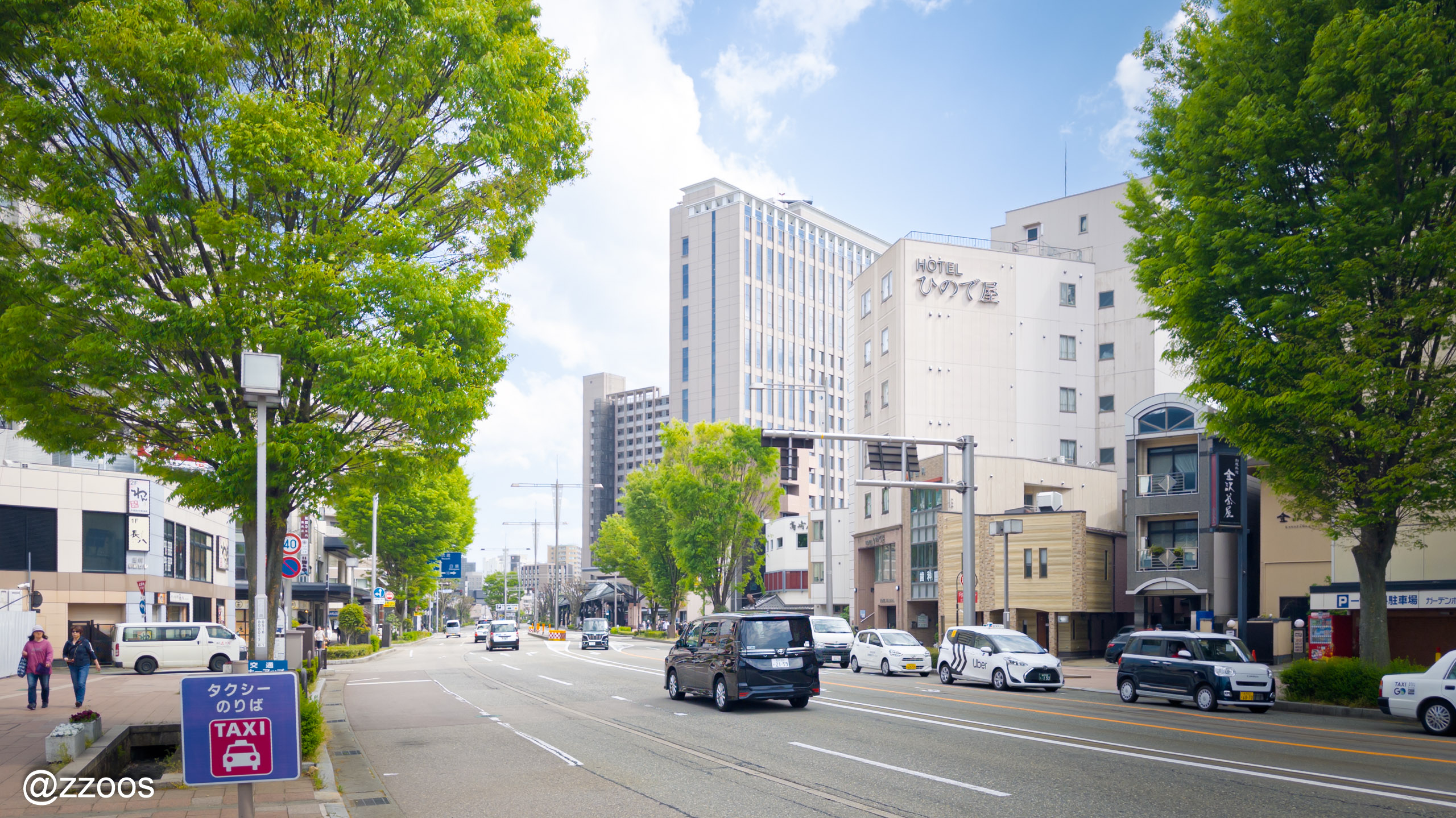 A Kanazawa street with tall buildings and cars