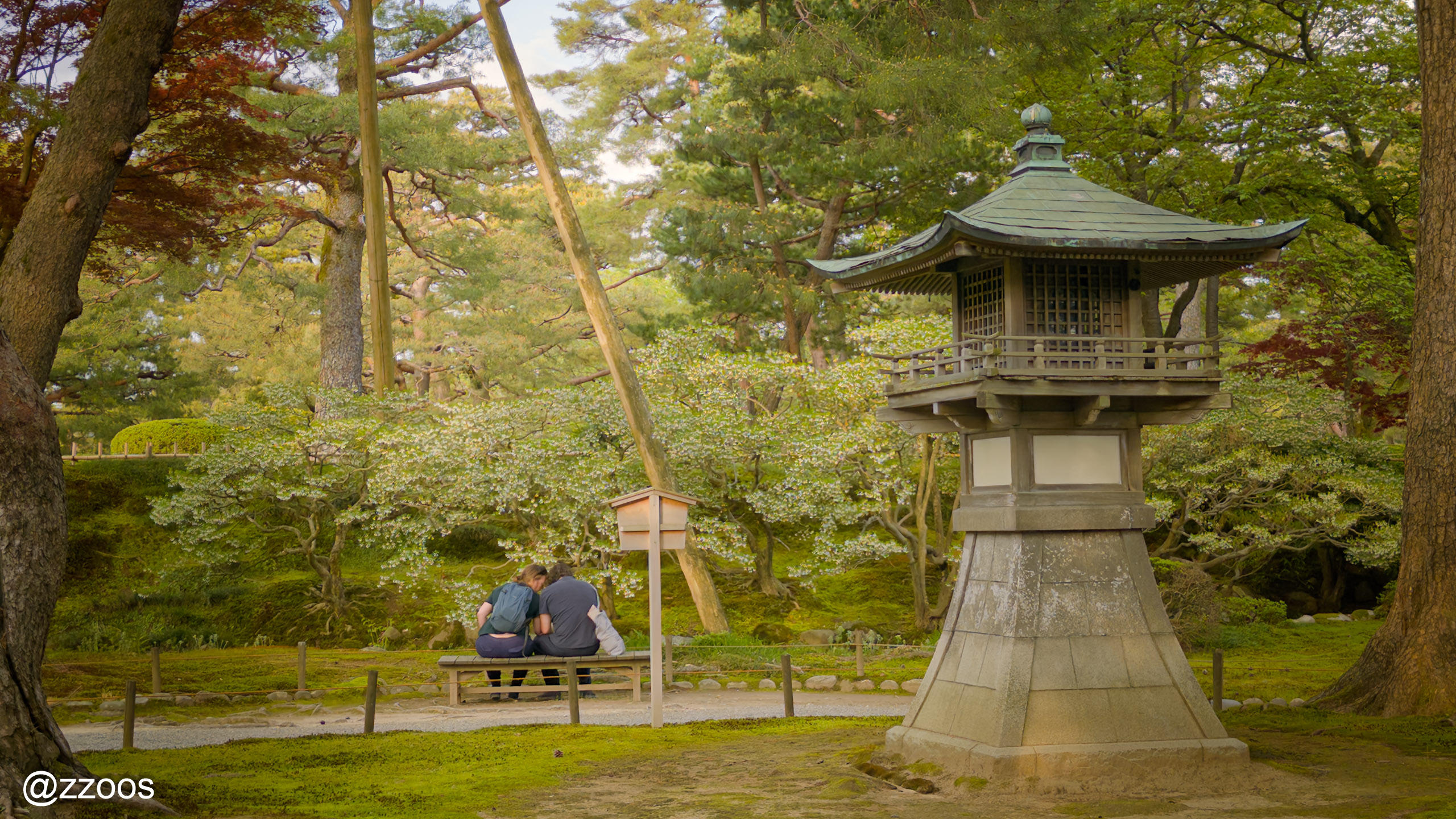 Person sitting on a bench at Kenrokuen Garden