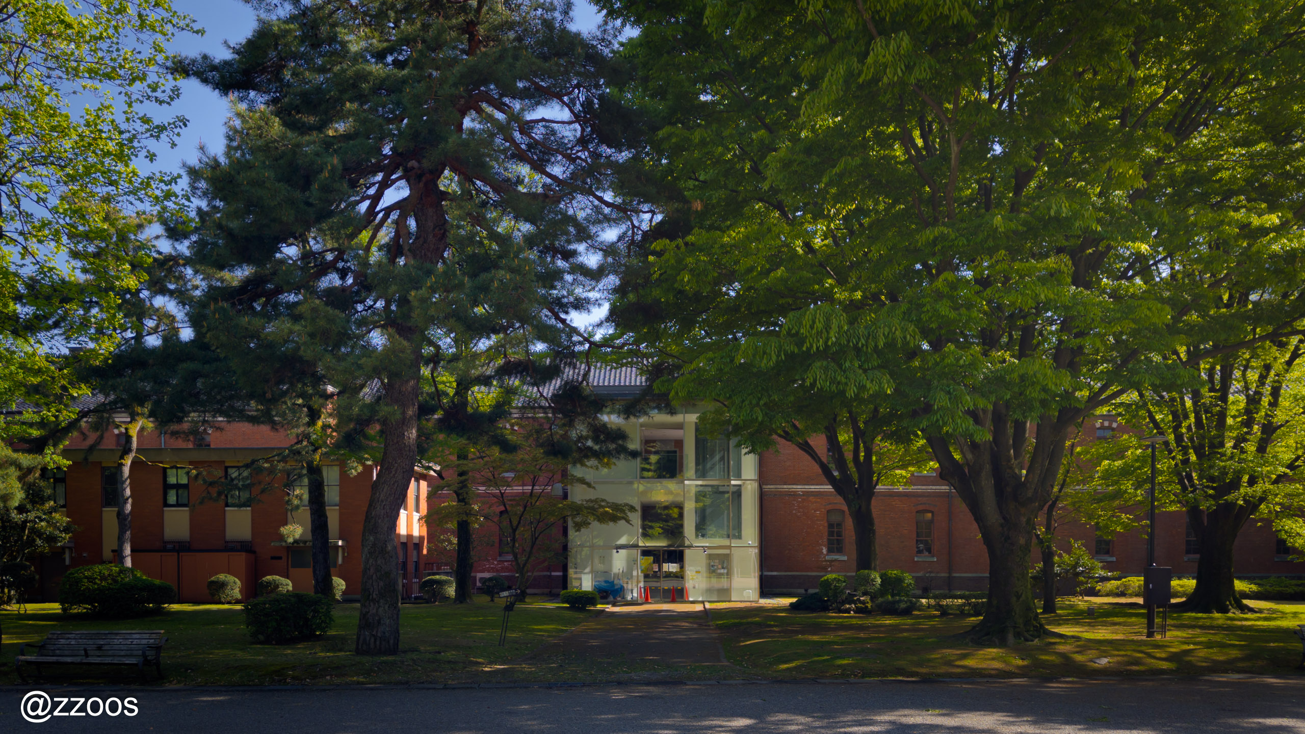 Former Fourth High School building with trees and lawn at Ishikawa Shiko Memorial Park
