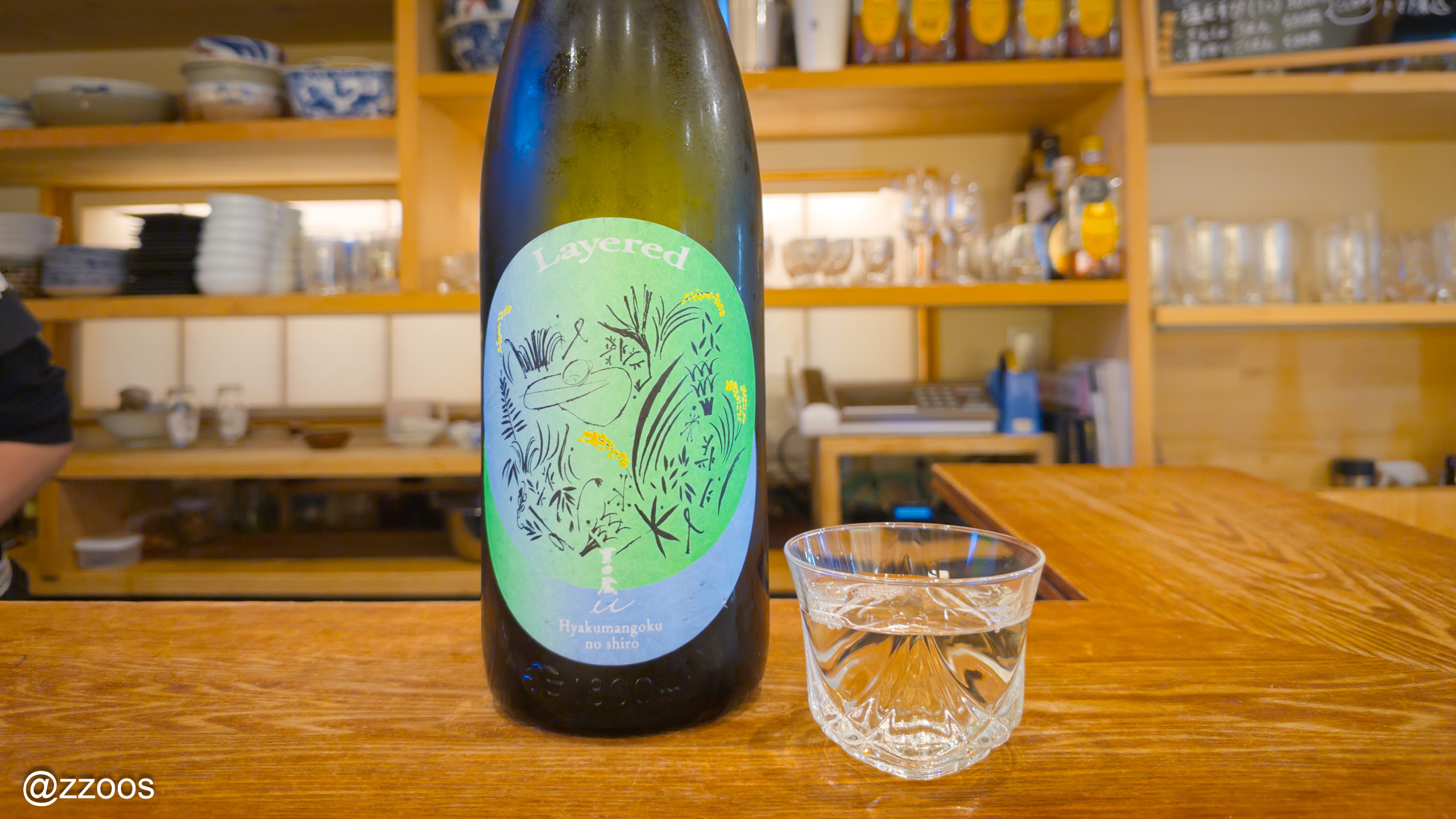 A glass of Tedorigawa Yoshida U Layered at Nihonshu Makoto