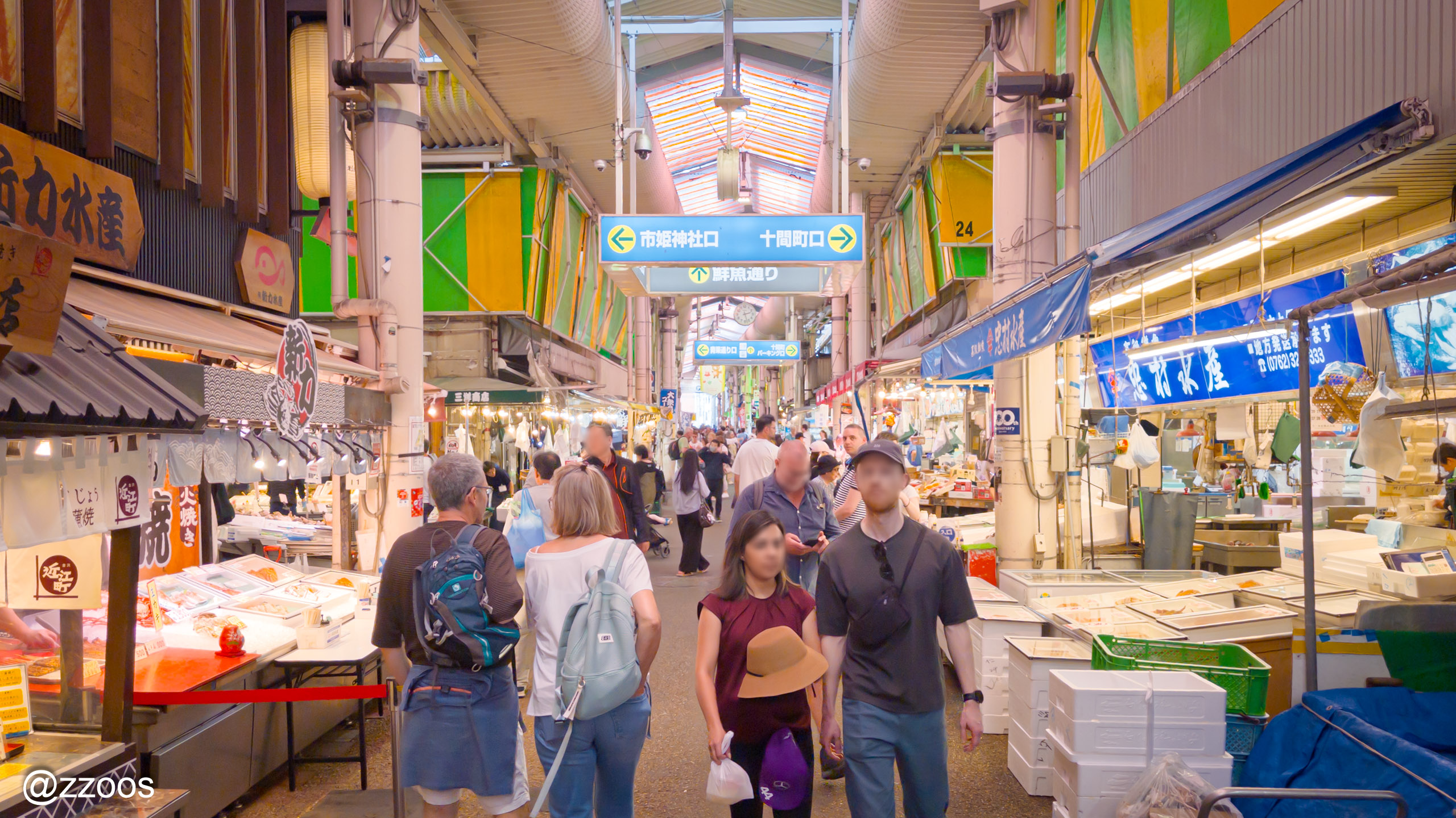 A lively shopfront scene inside Omicho Market