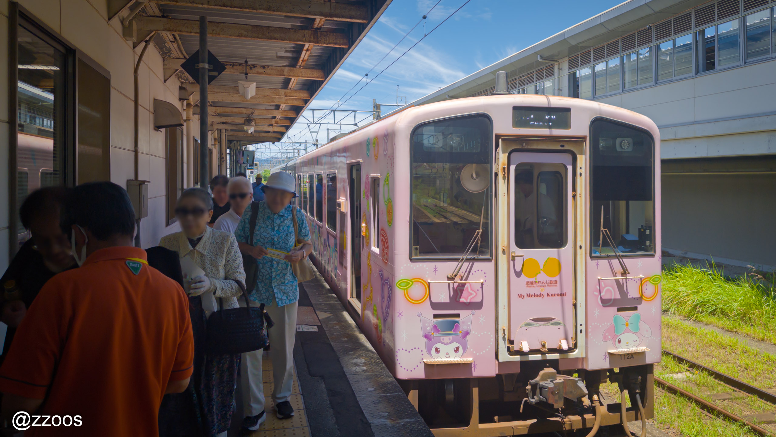 A pink Hisatsu Orange Railway train wrapped in Sanrio characters