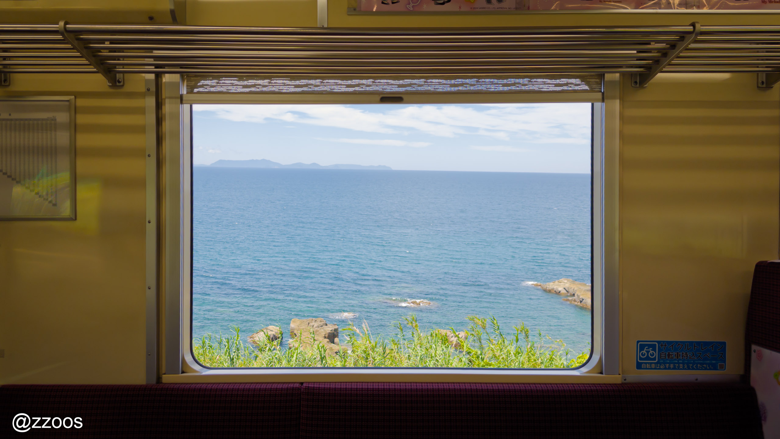 A Hisatsu Orange Railway train running along the sea