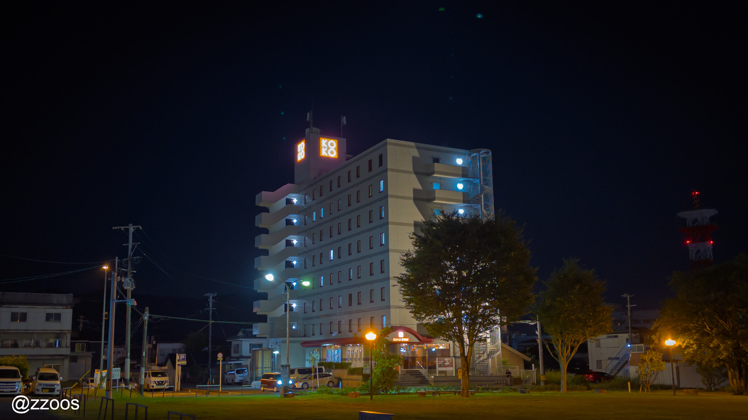 KOKO STAY Izumi at night, seen from across Izumi Station plaza