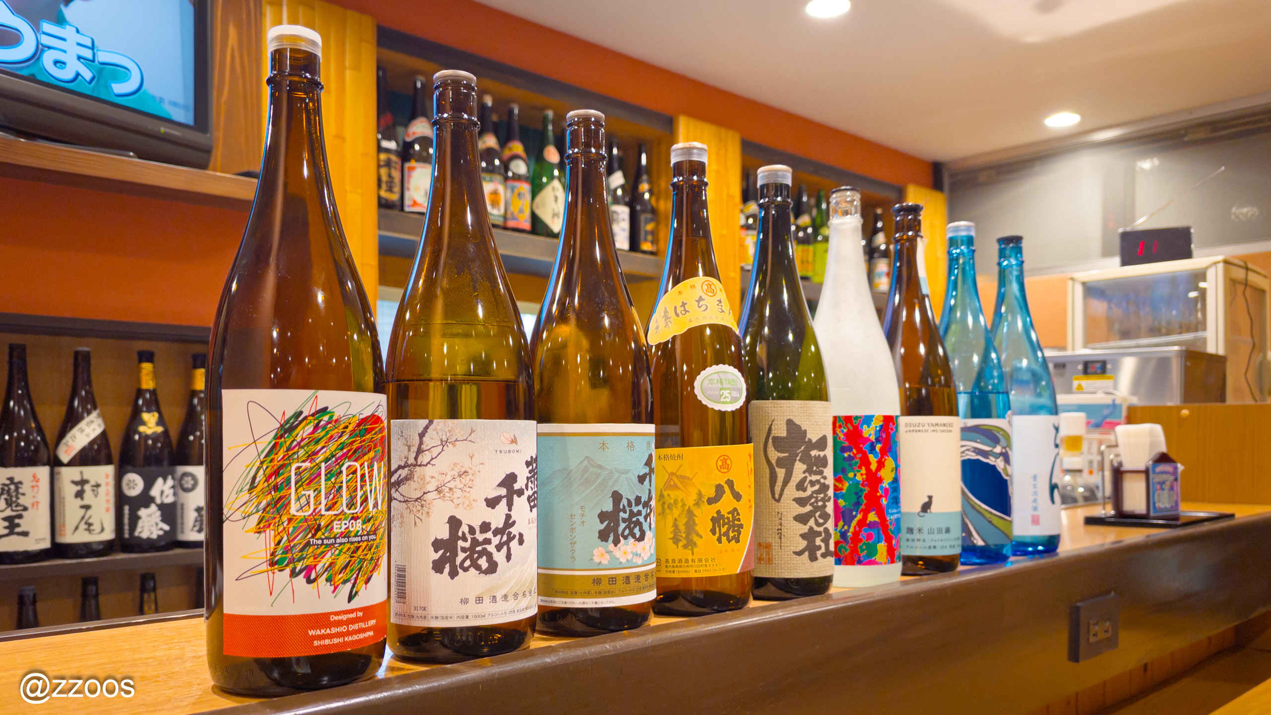 ゆめぜん出水店のカウンターにならぶ鹿児島の焼酎の瓶