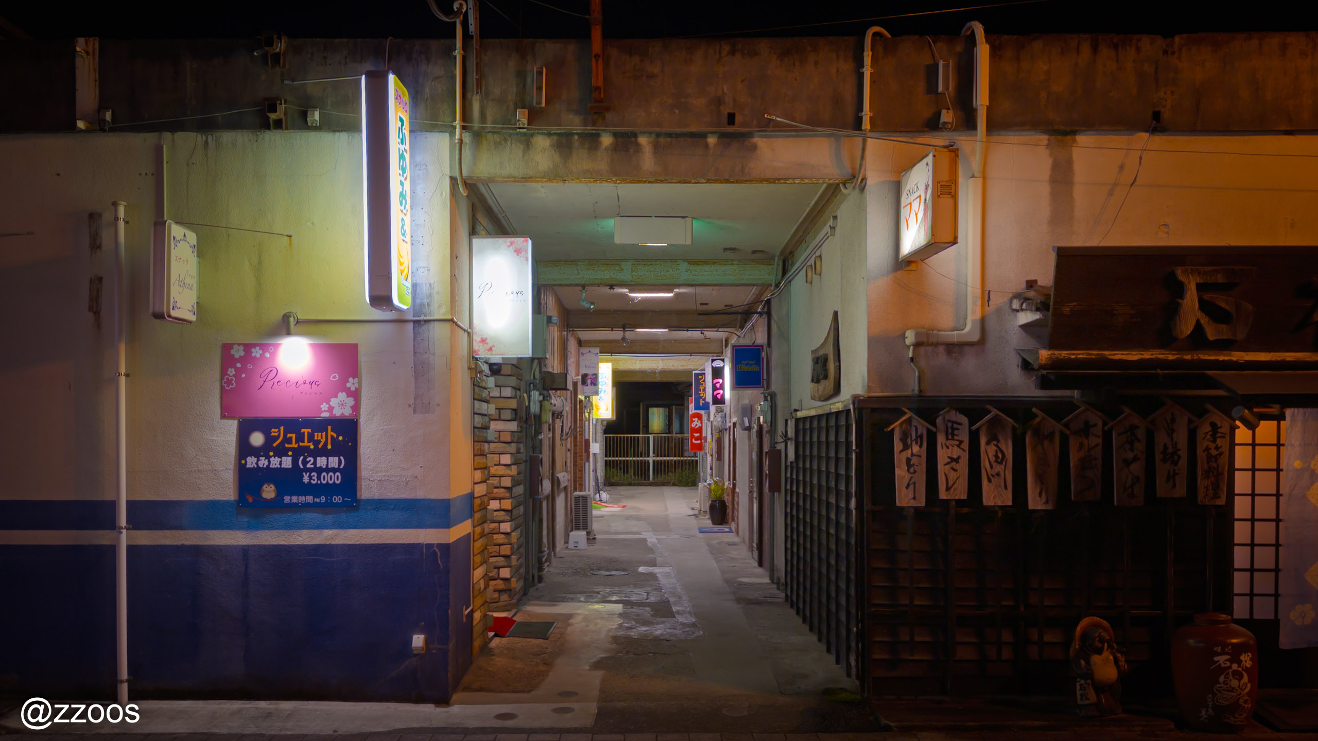 A night alley in Izumi lined with snack bars
