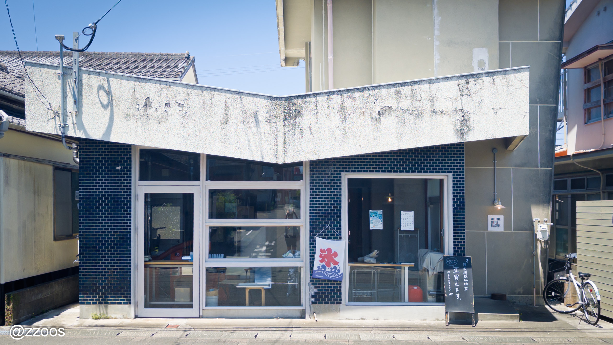 Exterior of Port Town Coffee Roasters, a cafe in a backstreet near Akune Station