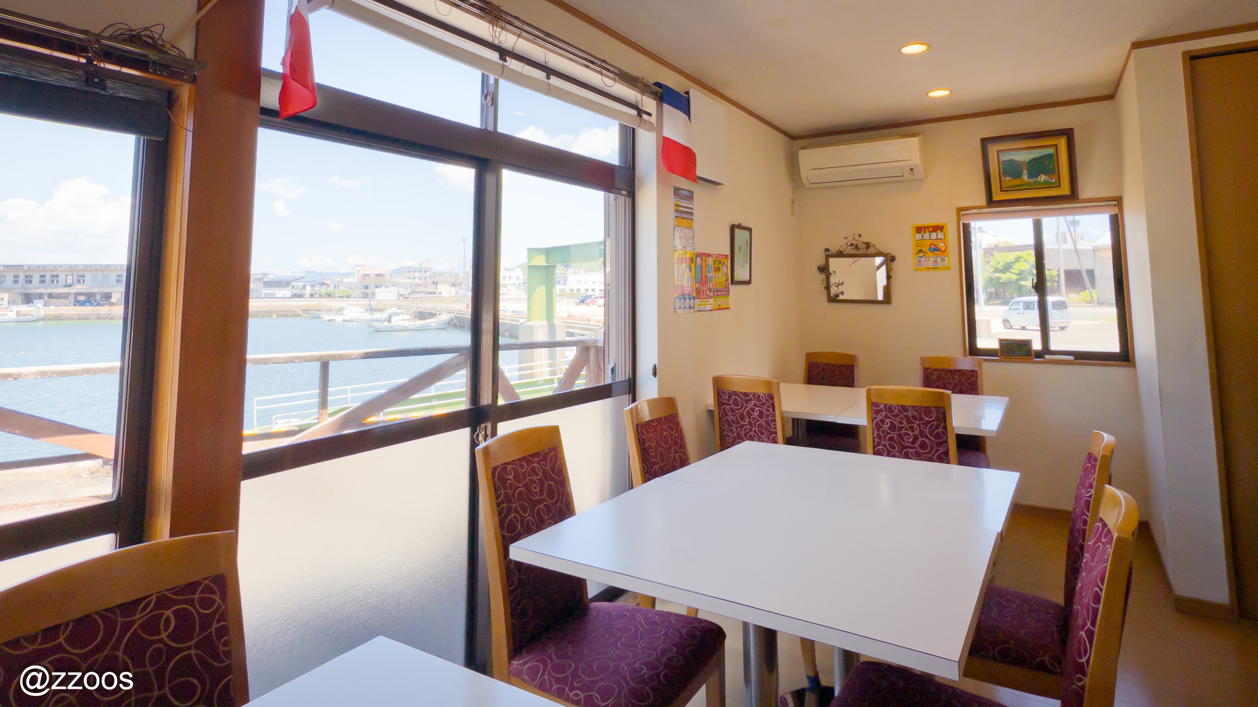 The simple interior of La Bonne Journée with a view of the sea