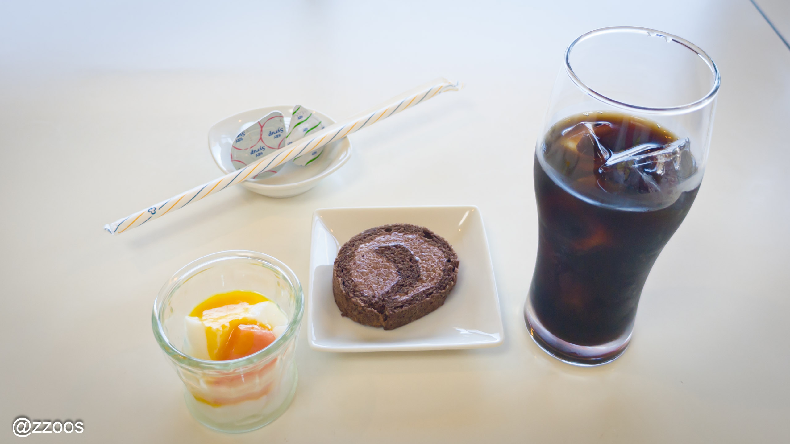 A dessert of pudding, roll cake, and iced coffee
